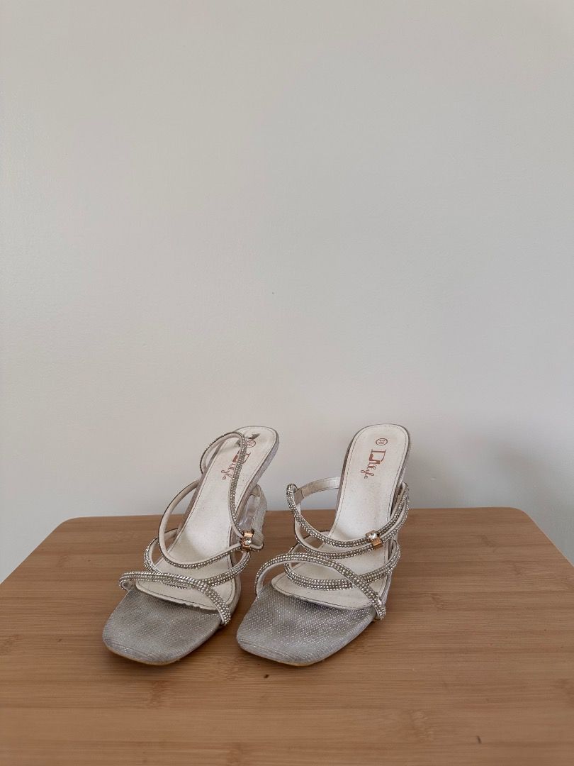 Silver open toe with strap on heels Size 38 (Category: Heels) located in Binan City. Submitted by themkeps (Listing ID 1364083485, Image 1). Description: Used for ball worn once tried to wash but the black marking is not coming off unknown brand comes with box .