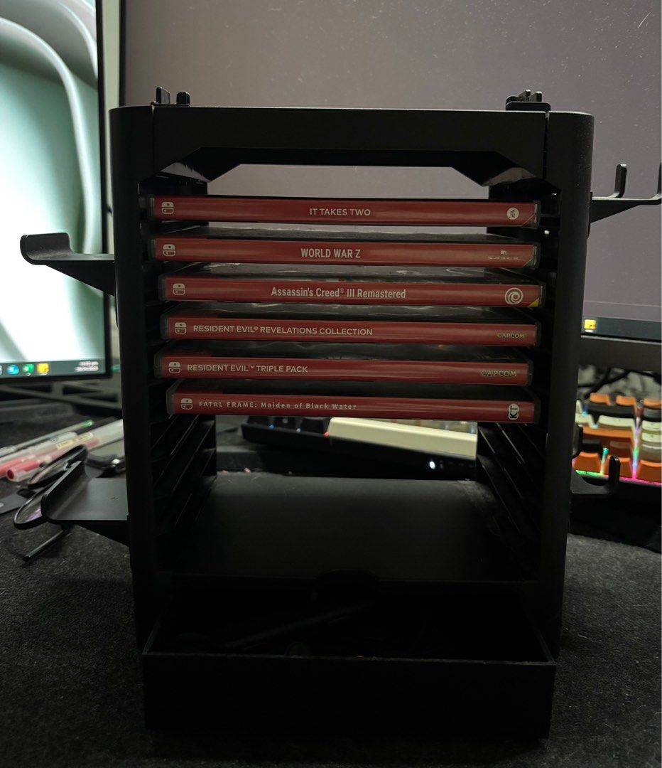 JYS One-Stop Multifunctional Game Storage Tower for Nintendo Switch (Category: Cases & Covers) located in Manila. Submitted by acl0413 (Listing ID 1364380892, Image 2). Description: - with controller holder on both sides - with mini storage - can hold up to 10 games - switch TV dock can be stacked on top.