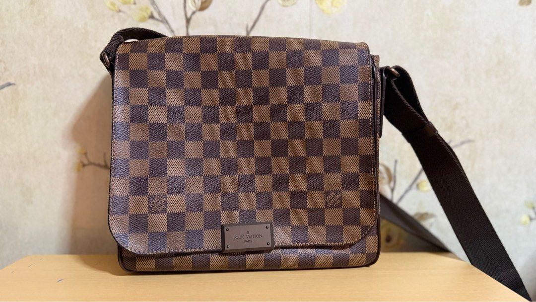 Louis Vuitton Damier Ebene Canvas District PM Bag (Category: Luxury Bags & Wallets) located in Manila. Submitted by lordfarquaad (Listing ID 1364369967, Image 2). Description: ❗️NEGOTIABLE❗️ Key Features: • Style: District PM • Material: Damier Ebene coated canvas with brown textile lining • Hardware: Gold-tone • Closure: Magnetic flap closure • Interior: One large compartment with slip pocket and smaller patch pocket • Strap: Adjustable canvas s