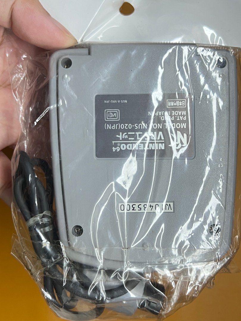 N64 Voice Recognition Unit (VRU) (Category: Controllers) located in Cavite. Submitted by majoh_retro (Listing ID 1364396765, Image 2). Description: The item shown is a Nintendo 64 Voice Recognition Unit (VRU). It was released as a peripheral for the Nintendo 64 console. It allows players to use voice commands in compatible games. The VRU connects to the N64 console and requires a microphone to function. It was primarily used with the game Hey You