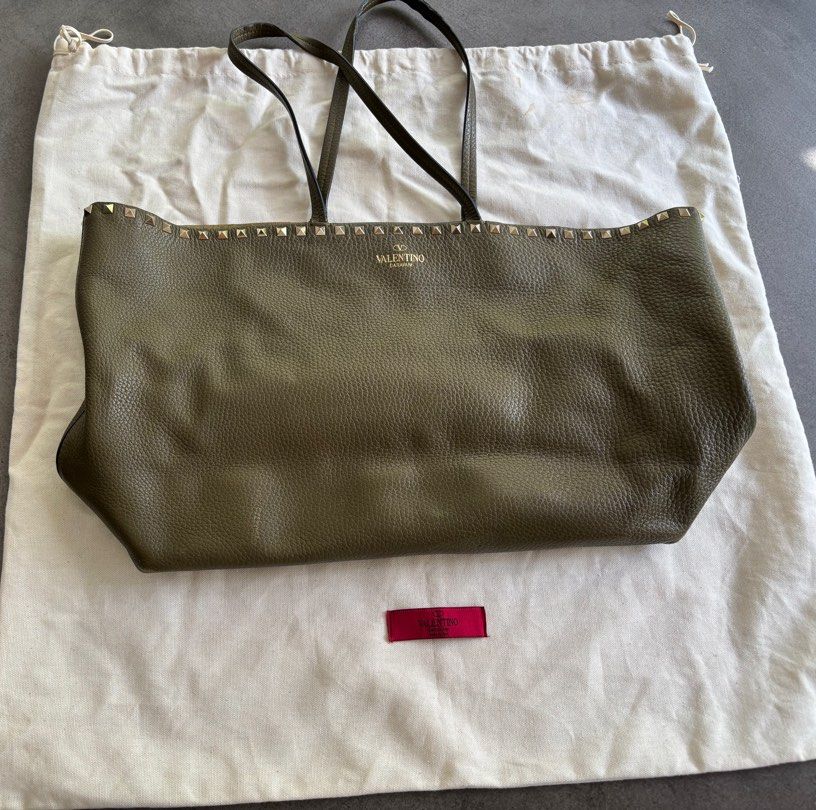 Valentino Rockstud Tote Bag (Category: Bags & Wallets) located in Singapore. Submitted by tsutsipop (Listing ID 1364248371, Image 2). Description: I'm clearing my closet and selling my well loved Valentino Tote. Scratches and tears throughout, they are all indicated in the pics. Not for fussy buyers!! Purchased for ~1,600 SGD, letting go for less than 20% of original price! Dimensions: 48cm (width) x 28cm (height) x 12cm (depth) Contains RFID tag