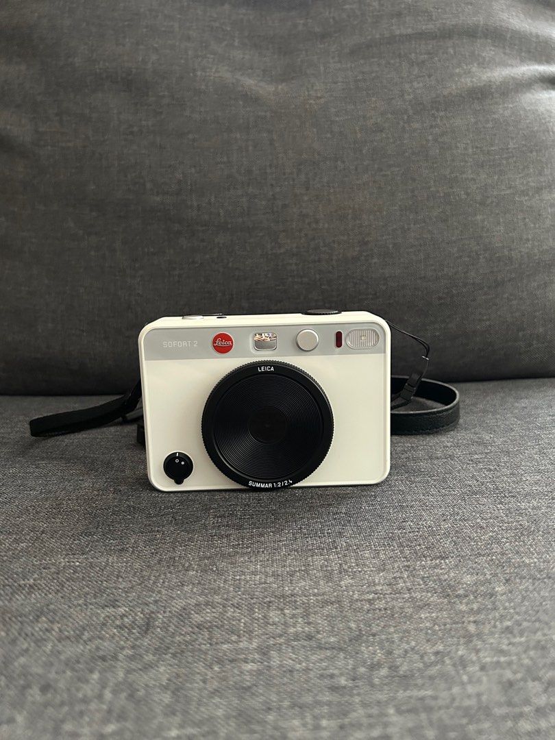 Pre-loved Leica Sofort 2 in White (Category: Cameras) located in Mandaluyong City. Submitted by nicesells01.823 (Listing ID 1364449423, Image 2). Description: RFS: Not being used Product Description: - Hybrid digital camera - can print polaroid photos or you can download the photos through a memory card - Only used a few times - Comes with the original box, charger, strap and free 1 packs of Instax - No visible signs of wear, only the lens cover 