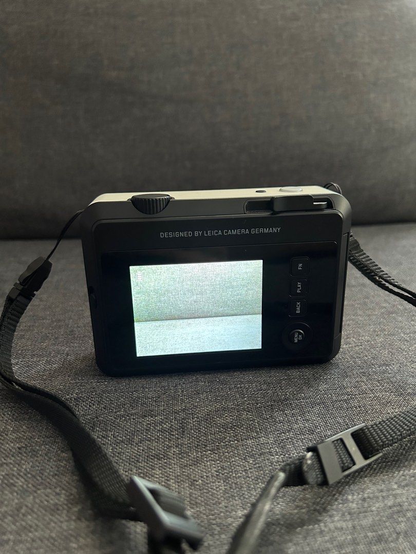 Pre-loved Leica Sofort 2 in White (Category: Cameras) located in Mandaluyong City. Submitted by nicesells01.823 (Listing ID 1364449423, Image 3). Description: RFS: Not being used Product Description: - Hybrid digital camera - can print polaroid photos or you can download the photos through a memory card - Only used a few times - Comes with the original box, charger, strap and free 1 packs of Instax - No visible signs of wear, only the lens cover 
