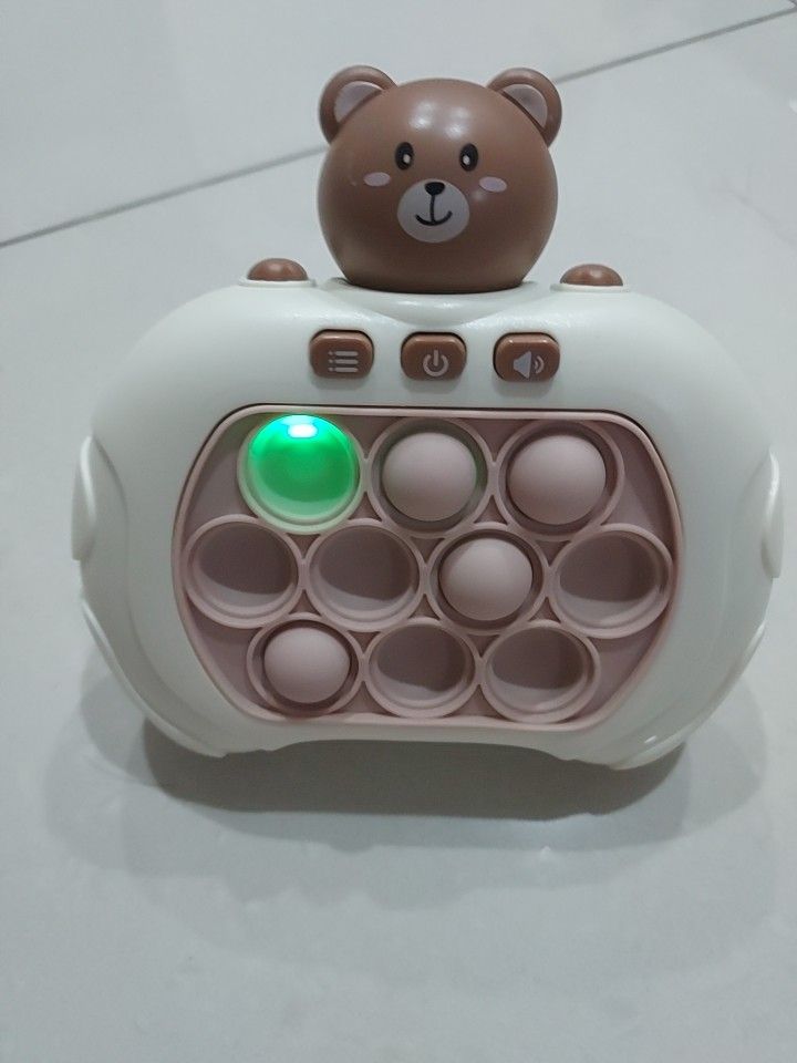 Pop It Fidget Toy with Bear Design in excellent condition (Category: Interactive Toys) located in Singapore. Submitted by wovey (Listing ID 1364688554, Image 1). Description: This is a Pop It fidget toy or quick-push game console with a cute bear design. It has 12 bubbles that you can pop and it makes a satisfying sound. It's a great way to relieve stress and anxiety. It's also a fun toy for kids. It's in lightly used condition and comes with a b
