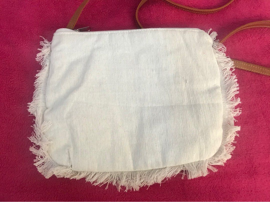 Canvas sling bag (Category: Cross-body Bags) located in Taguig. Submitted by decluttering_my_stuff (Listing ID 1364734953, Image 3). Description: -From Bali with hand embroidered design -never used -9in x 7.5in -Off white RFS: decluttering.