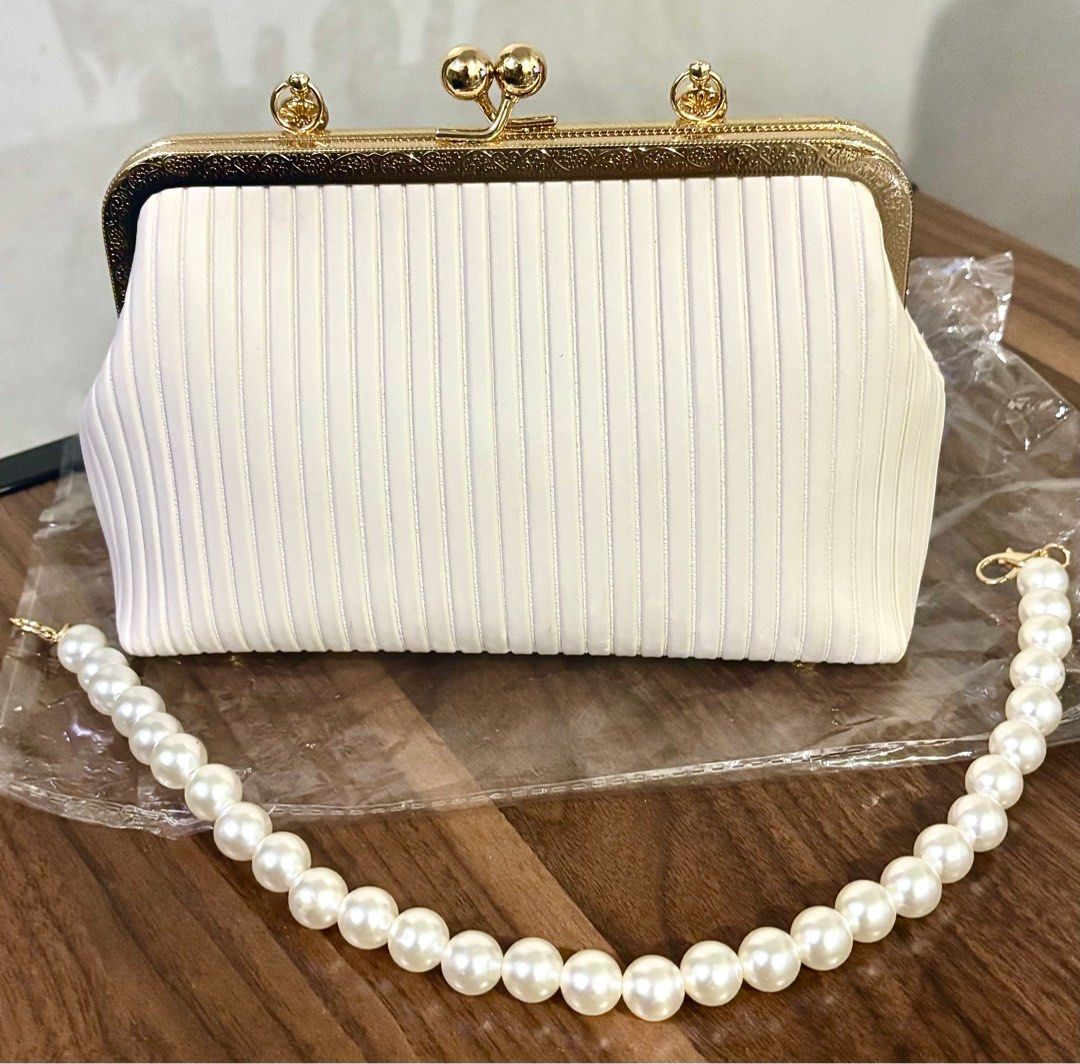 White hand bag (Category: Clutches) located in Mandaluyong City. Submitted by bea_dc (Listing ID 1364780853, Image 1). Description: + used once (wedding party) + has a pocket on the inside, PU Leather, kiss lock closure.