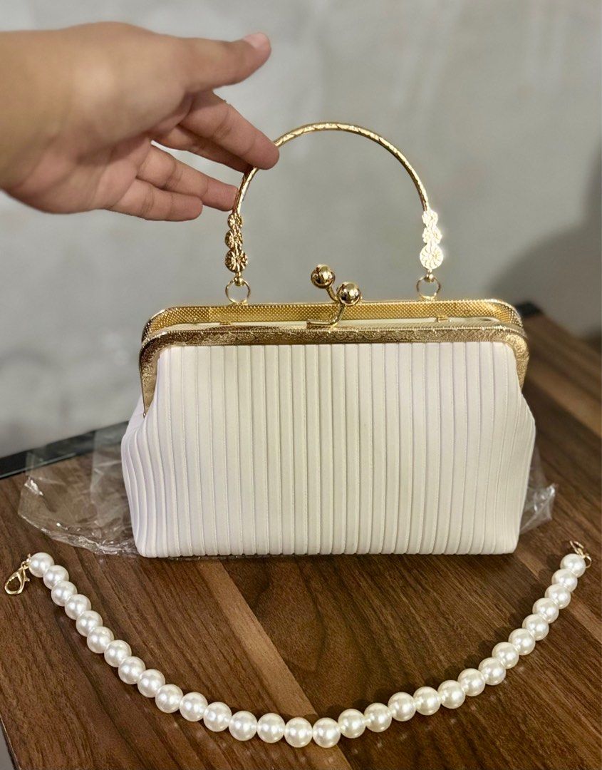 White hand bag (Category: Clutches) located in Mandaluyong City. Submitted by bea_dc (Listing ID 1364780853, Image 3). Description: + used once (wedding party) + has a pocket on the inside, PU Leather, kiss lock closure.