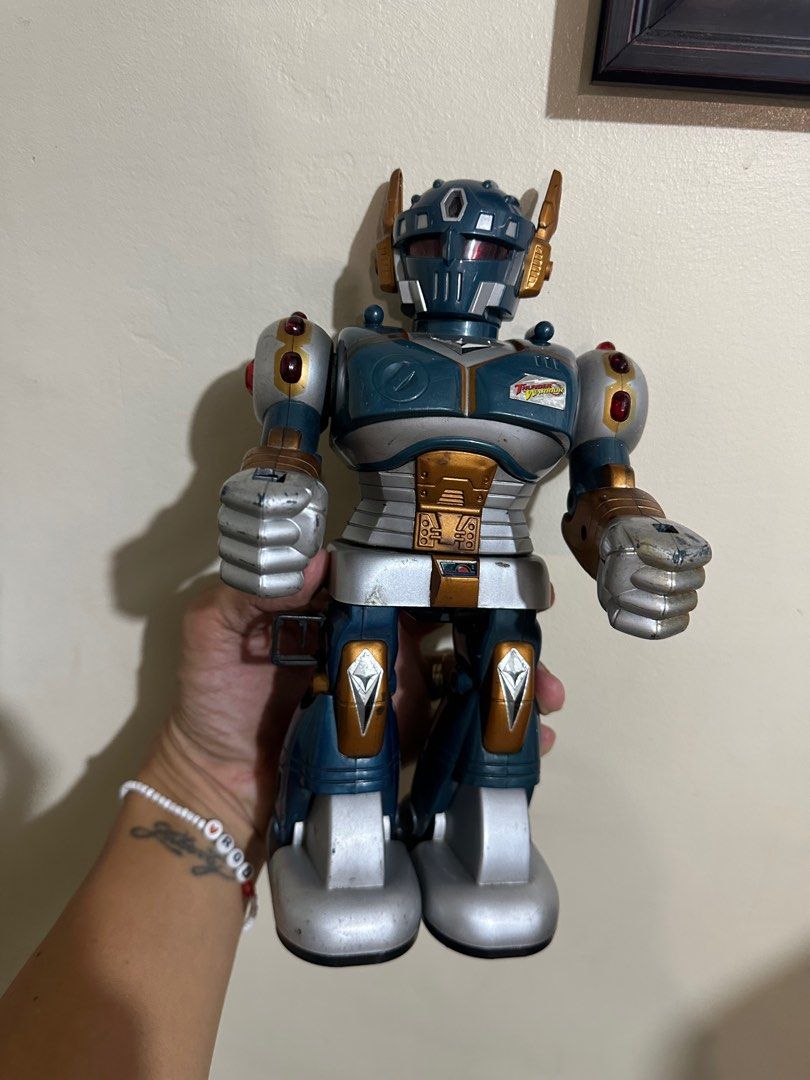 Thunder Warrior Lights Sounds Spinning Walking 10” Robot Hap-P-Kid 1997 (Category: Interactive Toys) located in Rodriguez. Submitted by pwestoonlinestore (Listing ID 1364882819, Image 1). Description: For Sale 800 pesos Issue: May mahinang tunog lang kapag nilagyan ng battery. Hindi na umiikot at umiilaw. Kayo nalang ang magrestore Walang ibang kasama Thunder Warrior Lights Sounds Spinning Walking 10” Robot Hap-P-Kid 1997.