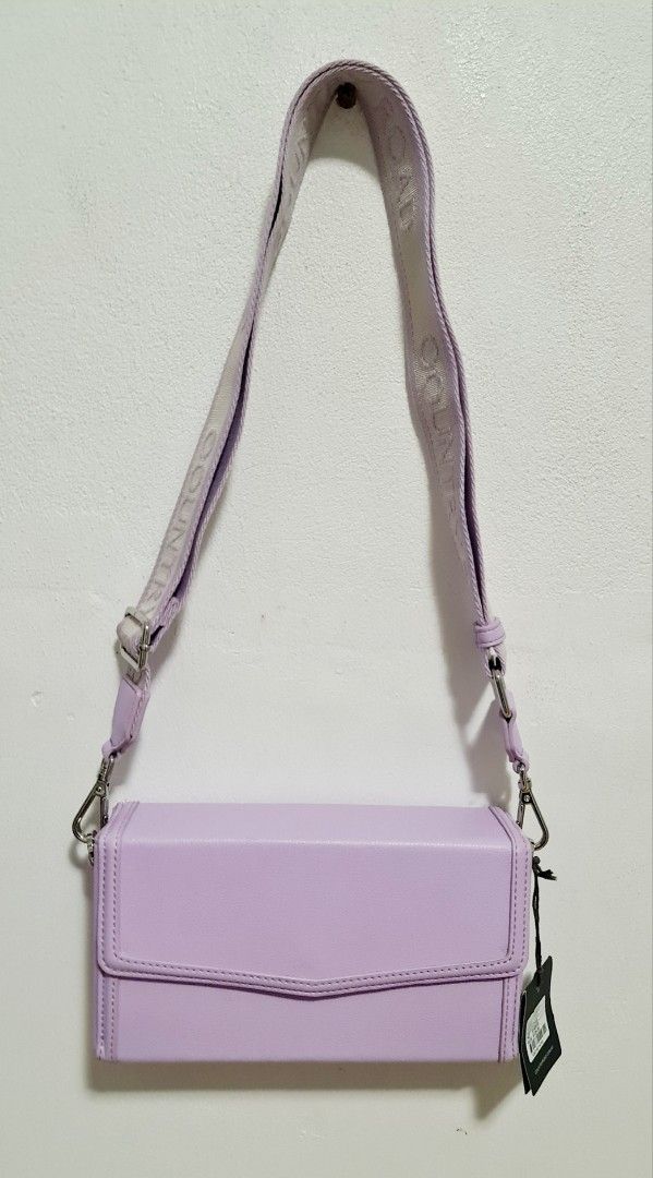 Brand New Country Road Lilac Crossbody Bag(New with Tags) (Category: Women's Bags & Wallets) located in Sydney. Submitted by desirably (Listing ID 1365035099, Image 3). Description: Brand new Country Road Lilac crossbody bag for $55(RRP $129). Brand new with tags. A modern structure silhouette with a fold-over flap and magnetic tab closure. Made using a lightly textured woven outer, it features a contrast pebble-textured edge and an adjustable, r