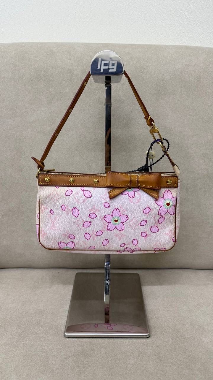 Louis Vuitton X Takashi Murakami Pochette in Pink Cherry Blossom (Category: Bags & Wallets) located in Singapore. Submitted by projectlfg (Listing ID 1365046650, Image 2). Description: Louis Vuitton X Takashi Murakami Pochette in Pink Cherry Blossom Condition 98% New. Year: AR0023 Accessories: - Size: 21x3.5x12 / SGD: 1800 • ACRA Registered Company in Singapore • Physical Outlets in Singapore and China • Entrupy Verified Business • Authenticity G