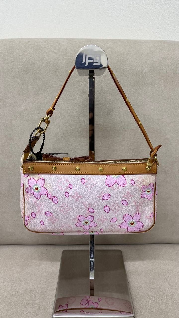 Louis Vuitton X Takashi Murakami Pochette in Pink Cherry Blossom (Category: Bags & Wallets) located in Singapore. Submitted by projectlfg (Listing ID 1365046650, Image 3). Description: Louis Vuitton X Takashi Murakami Pochette in Pink Cherry Blossom Condition 98% New. Year: AR0023 Accessories: - Size: 21x3.5x12 / SGD: 1800 • ACRA Registered Company in Singapore • Physical Outlets in Singapore and China • Entrupy Verified Business • Authenticity G