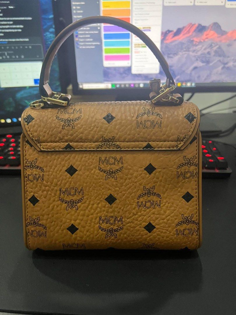 MCM heritage mini satchel in visetos (Category: Luxury Bags & Wallets) located in Cebu City. Submitted by rjcdadi (Listing ID 1365115926, Image 2). Description: Selling my personal pre loved mcm satchel. Purchased from MCM Korea. Complete with sling strap, dust-bag, lock and key. Condition: 7/10 minimal signs of use. Comes with authenticity certificate for your peace of mind. RFS: no longer using it as much..decluttering You may send me a message
