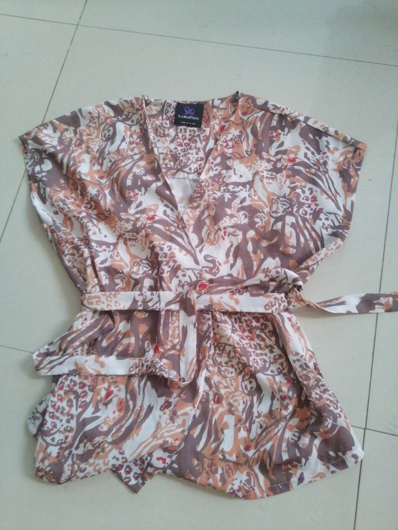 Plains and prints wrap around top (Category: Blouses) located in Cabanatuan. Submitted by misshell26 (Listing ID 1365125495, Image 1). Description: Like new.