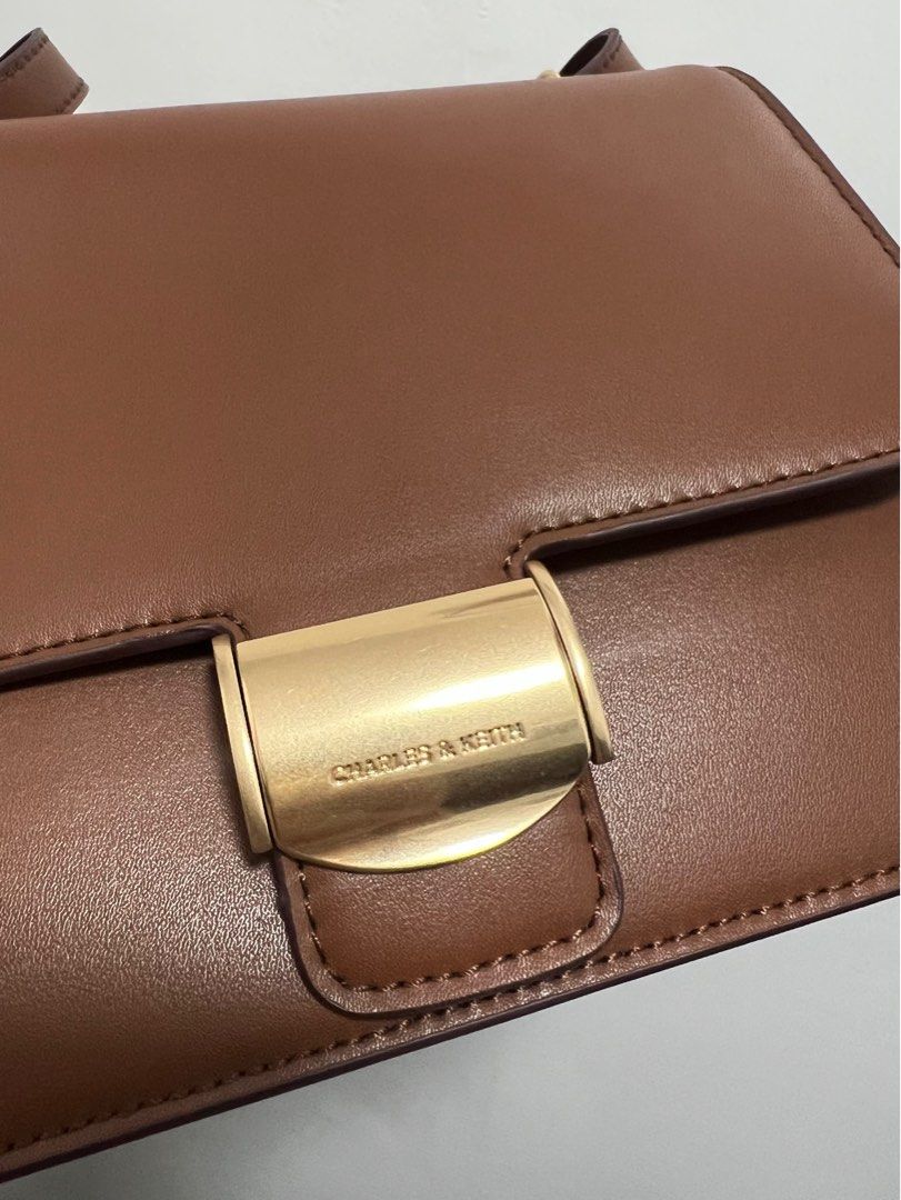 Charles & Keith - Chocolate Violetta Boxy Bag (Category: Shoulder Bags) located in Pasay City. Submitted by ksani (Listing ID 1365468935, Image 3). Description: Charles & Keith - Chocolate Violetta Boxy Bag •Actual pictures •No issue/flaw. Mint condition. •Comes with dustbag.