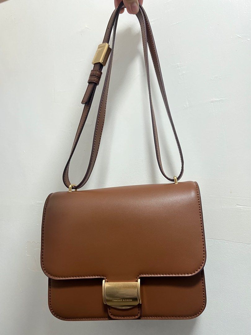 Charles & Keith - Chocolate Violetta Boxy Bag (Category: Shoulder Bags) located in Pasay City. Submitted by ksani (Listing ID 1365468935, Image 1). Description: Charles & Keith - Chocolate Violetta Boxy Bag •Actual pictures •No issue/flaw. Mint condition. •Comes with dustbag.
