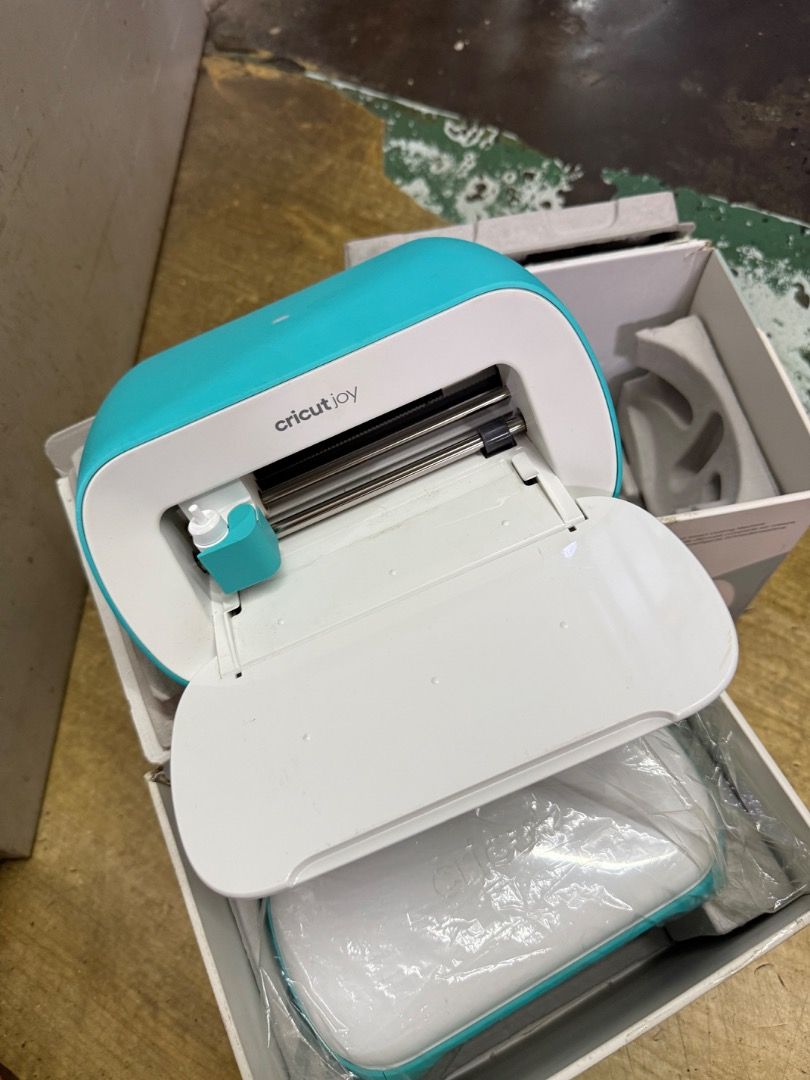 Cricut Joy Smart Cutting Bluetooth vinyl cutter sticker maker cutting plotter (Category: Printers, Scanners & Copiers) located in Singapore. Submitted by luckpals (Listing ID 1365350214, Image 1). Description: Cricut joy Starter model Comes with free app access 2 units to clear. Slight scatches on device. Comes with power adapter only. Add on brand new card mat for $12 .
