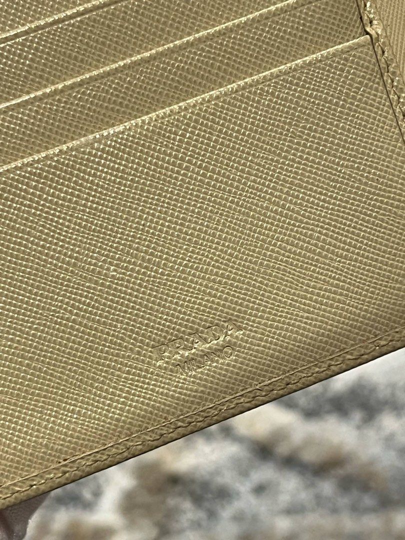 For Sale Original Prada Wallet (Category: Luxury Bags & Wallets) located in Caloocan City. Submitted by dandannnn2525 (Listing ID 1365416872, Image 2). Description: Prada Saffiano Compact Wallet Color: Beige Condition: as per inspection, mukhang nag undergone ng color retouch, over all useable pa naman ang leather, may mga minimal stains lang as seen in the photo. .