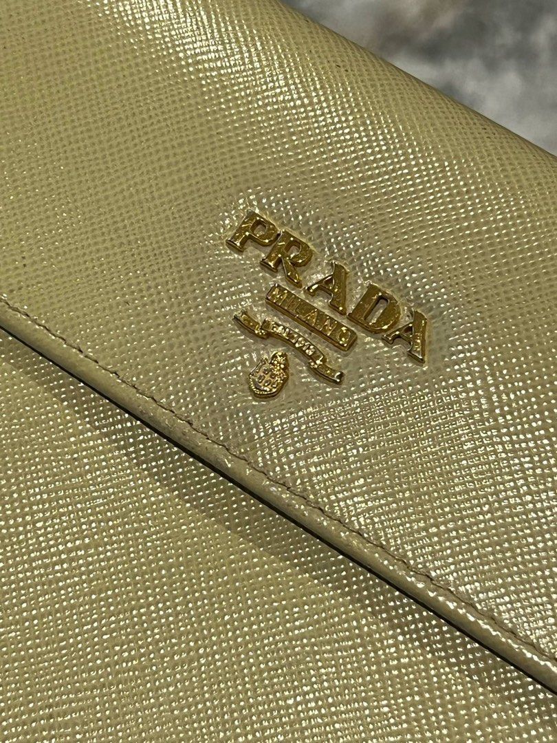 For Sale Original Prada Wallet (Category: Luxury Bags & Wallets) located in Caloocan City. Submitted by dandannnn2525 (Listing ID 1365416872, Image 1). Description: Prada Saffiano Compact Wallet Color: Beige Condition: as per inspection, mukhang nag undergone ng color retouch, over all useable pa naman ang leather, may mga minimal stains lang as seen in the photo. .