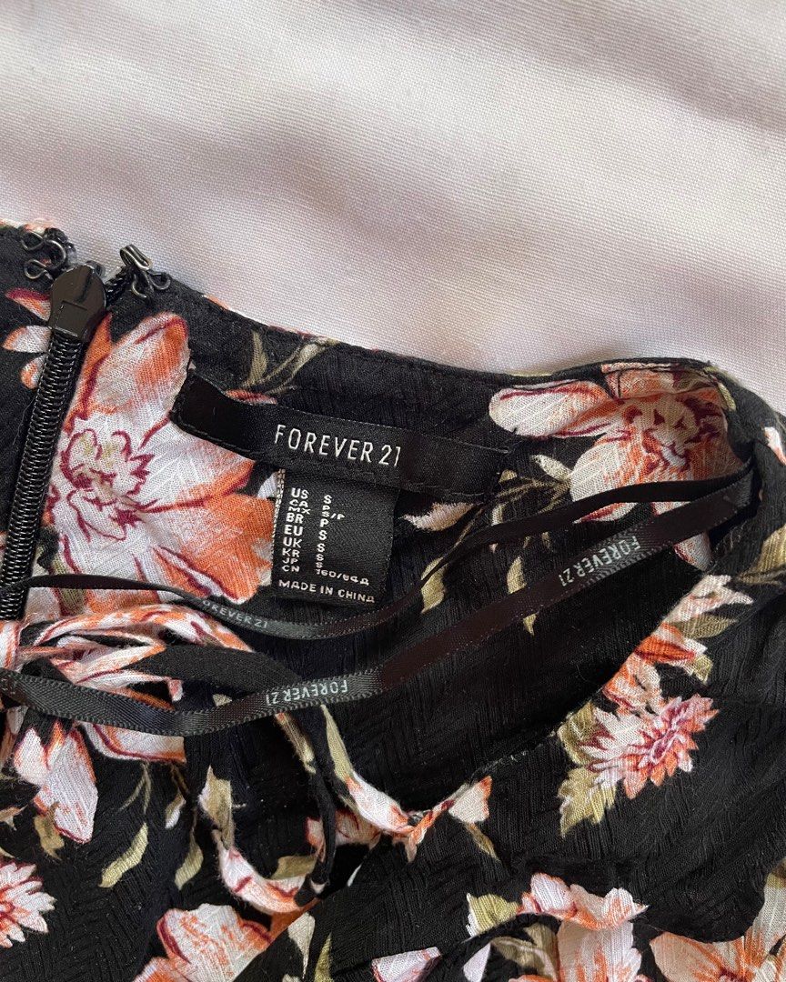 Forever 21 low cut mini dress (Category: Dresses) located in Santa Margarita. Submitted by vstrove (Listing ID 1365419941, Image 2). Description: FREE SHIPPING Flaw: see last photo other than that, dress is in good condition Black floral Cute ruffle and tie front detail .