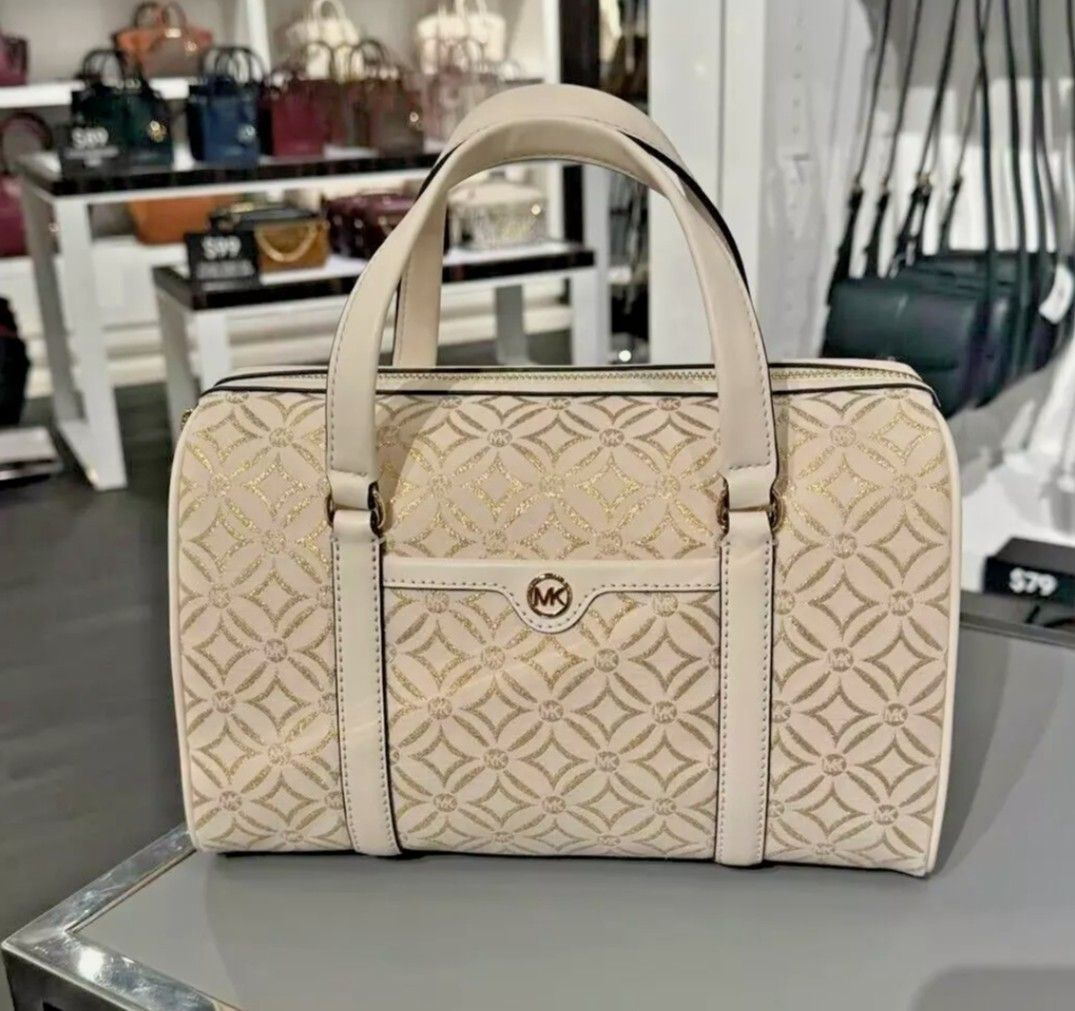 MK Medium Duffle Satchel Bag in White-Gold (Category: Luxury Bags & Wallets) located in Dasmarinas. Submitted by lovedbyleslee (Listing ID 1365480497, Image 1). Description: 💯ORIGINAL from US, moneyback guaranteed with tag (retails for 678$) with long leather strap.