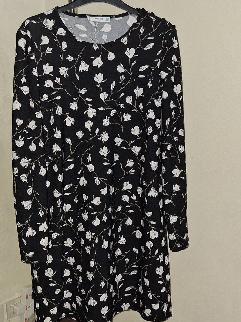 MANGO midi floral dress (Category: Dresses) located in Makati City. Submitted by worn2work_treasures (Listing ID 1365695599, Image 3). Description: Elegant and modest black A-line dress with a delicate floral pattern and long sleeves—perfect for semi-formal occasions. I'm 5'4", and the length falls about 1 inch above the knee, offering a classy and comfortable fit. I usually wear this to church, but it's also great for brunches, family gatherings