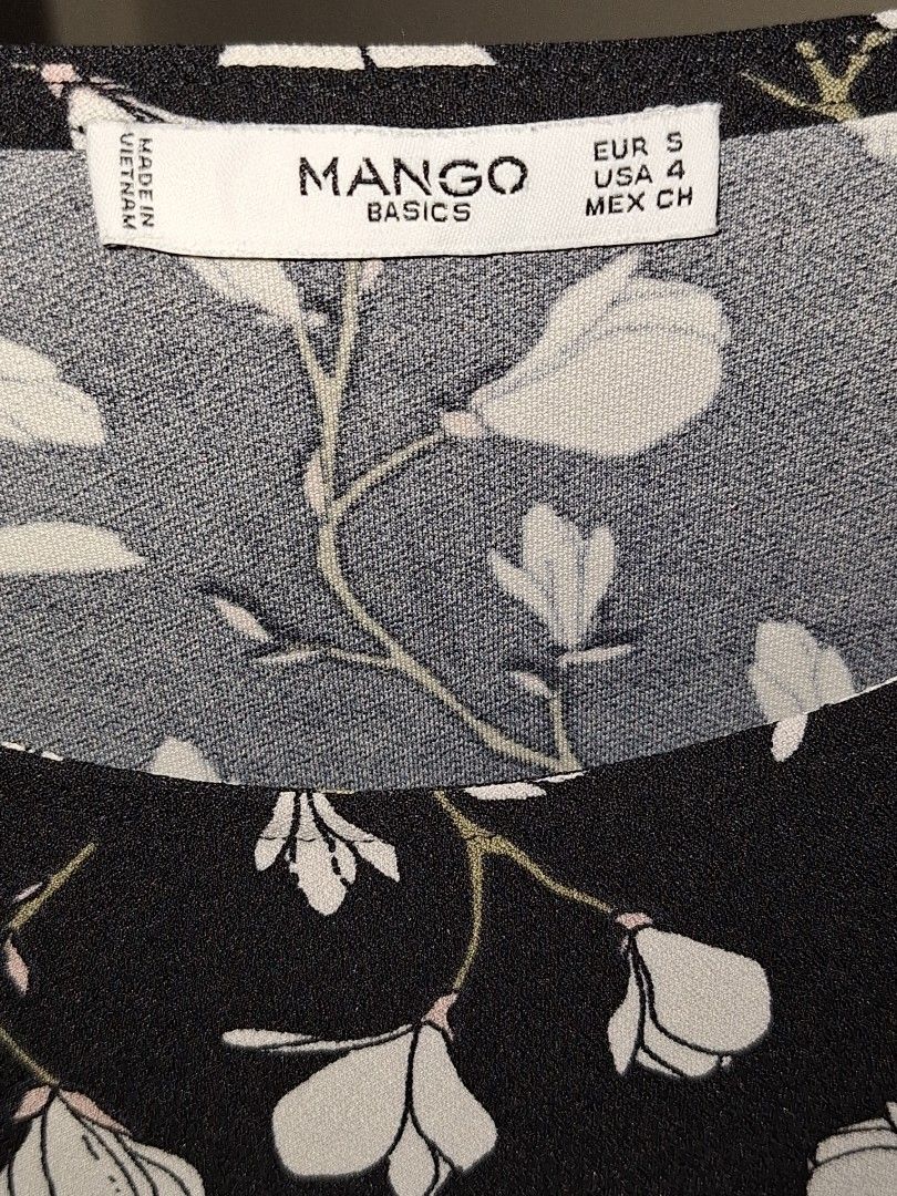 MANGO midi floral dress (Category: Dresses) located in Makati City. Submitted by worn2work_treasures (Listing ID 1365695599, Image 2). Description: Elegant and modest black A-line dress with a delicate floral pattern and long sleeves—perfect for semi-formal occasions. I'm 5'4", and the length falls about 1 inch above the knee, offering a classy and comfortable fit. I usually wear this to church, but it's also great for brunches, family gatherings