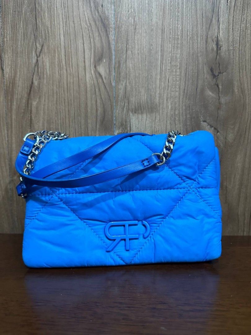 Blue mini shoulder bag [Parfois] original (Category: Shoulder Bags) located in Makati City. Submitted by dontforgetmenot (Listing ID 1365932483, Image 1). Description: 💙 preloved mini kili bag 💙 puffy bag which is super cute 💙 minor stains as shown but not noticable 💙 pm for more details.