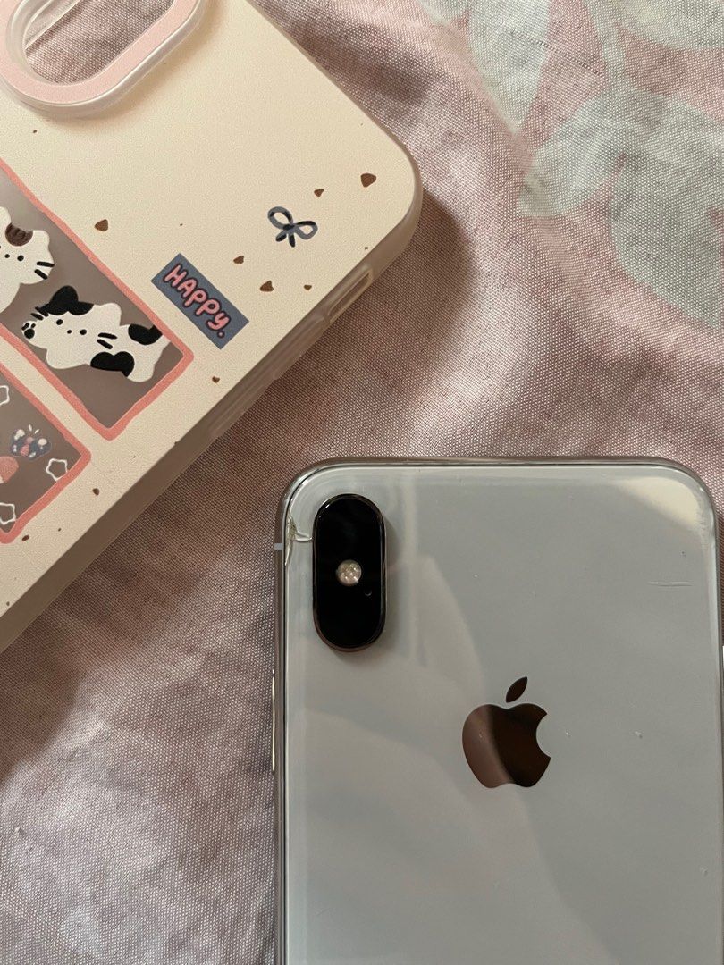 iPhone X 256gb (Category: iPhone X Series) located in Tuguegarao City. Submitted by yichuyaa07 (Listing ID 1365905656, Image 3). Description: iPhone x 256gb Silver bought as preloved Face ID working No true tone Clear camera Issues: - crack near the camera (but it doesn’t affect photos) rfs: - already upgraded & i need funds for an iPad Inclusion: - 2m connector from baseus (well-used) - 2 cases - Privacy tempered glass .