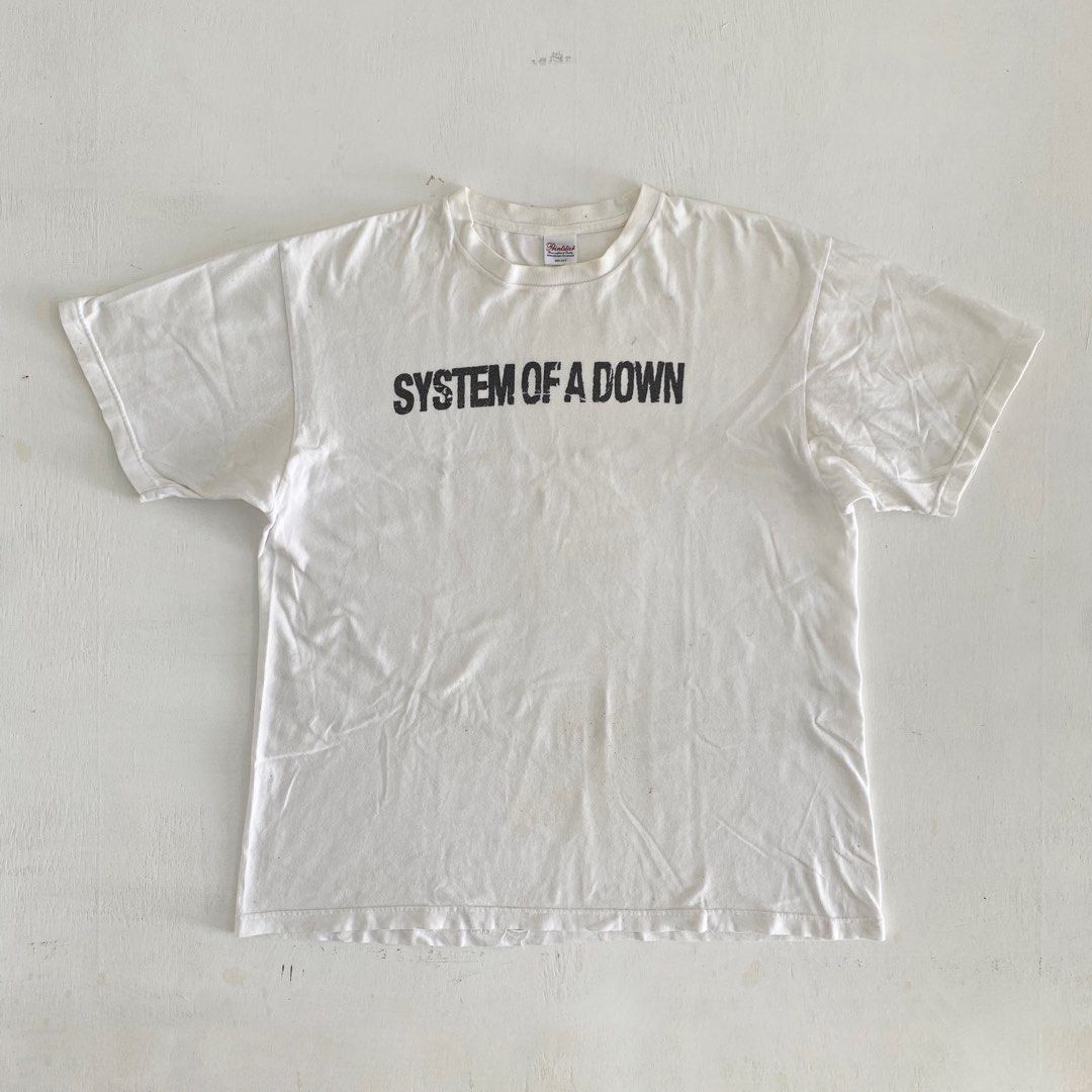 Y2K System Of A Down (SOAD) spellout Tshirt (Category: Tshirts & Polo Shirts) located in Johor Bahru. Submitted by h_________ (Listing ID 1366168637, Image 1). Description: Y2K System Of A Down (SOAD) spellout tshirt Size (ukuran manual): 22.5” (chest)x 27.5” Colour: White Condition: 8/10 (refer photo).