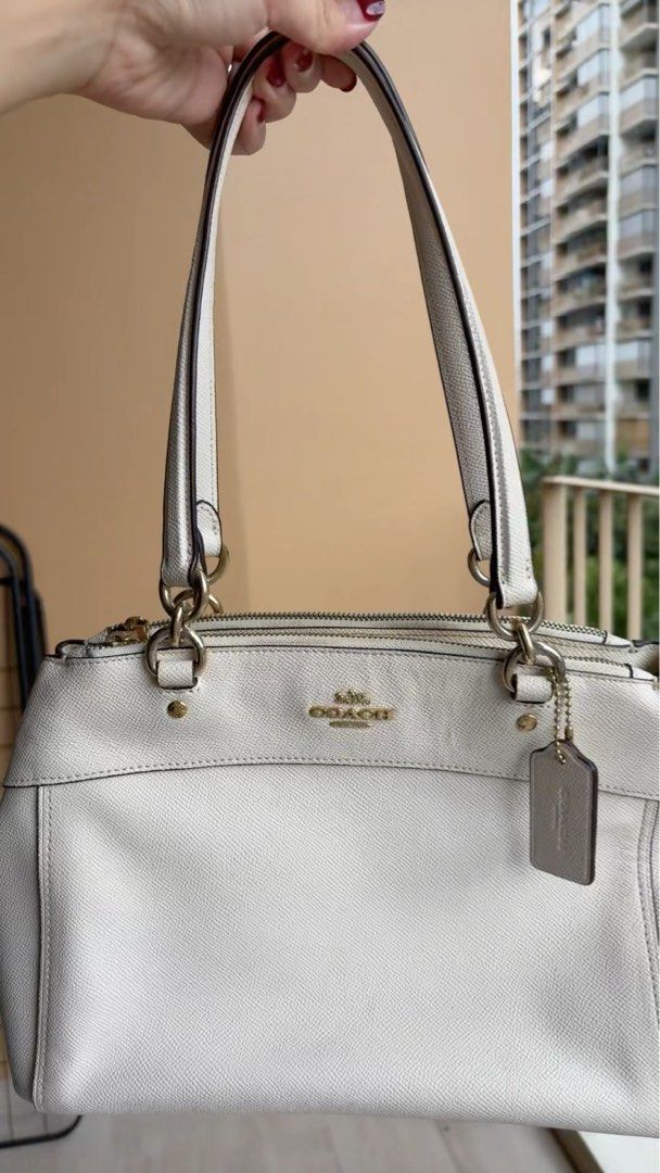 Coach Leather Handbag (Category: Bags & Wallets) located in Singapore. Submitted by hellocr (Listing ID 1366103256, Image 1). Description: This is a pre-loved Coach handbag. It is made of leather and has a gold-tone hardware. The bag has been used quite a bit and shows signs of wear and tear. It is still in good condition and can be used for everyday use. It has a zipper closure, a top handle and can be worn as a sling bag. The bag is perfect for