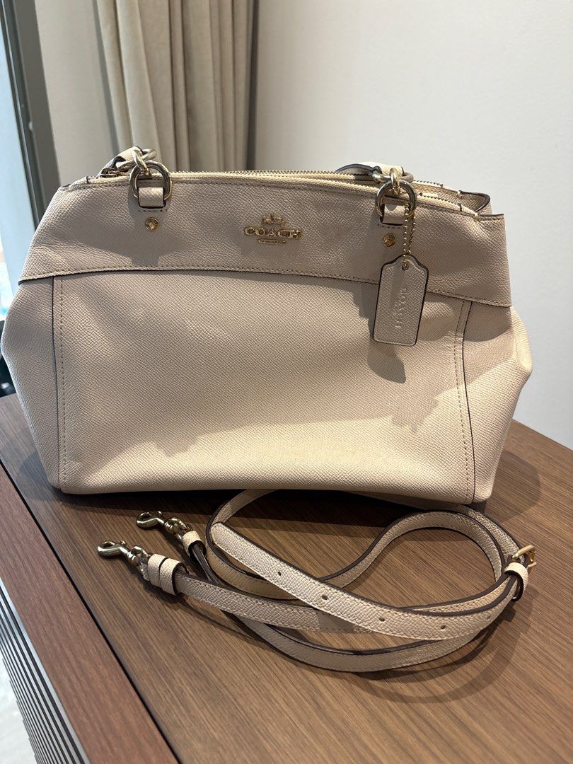 Coach Leather Handbag (Category: Bags & Wallets) located in Singapore. Submitted by hellocr (Listing ID 1366103256, Image 2). Description: This is a pre-loved Coach handbag. It is made of leather and has a gold-tone hardware. The bag has been used quite a bit and shows signs of wear and tear. It is still in good condition and can be used for everyday use. It has a zipper closure, a top handle and can be worn as a sling bag. The bag is perfect for