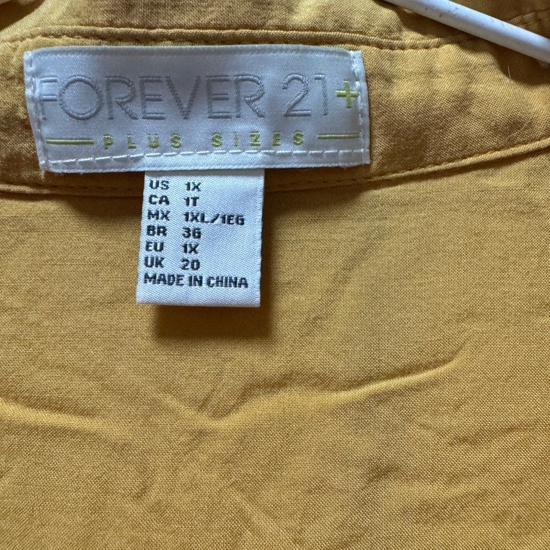 Forever21 plus size blouse top (Category: Blouses) located in Cainta. Submitted by kei_21 (Listing ID 1366292116, Image 2). Description: Closet cleanup sale Decluttering Forever21 Front tie top with collar Size 1x Can fit bust 38, waist 34-36 Mustard yellow With flaw at the back (pls check last photo) Loc: pasig .