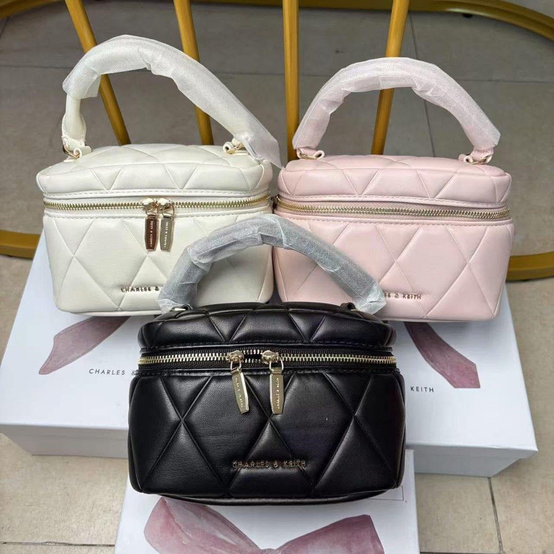 Charles & Keith Arwen Quilted Vanity Bag (Category: Cross-body Bags) located in Pasig City. Submitted by ff.ph (Listing ID 1366533619, Image 2). Description: Limited Edition With Gift Box Top Handle Vanity bag Soft quilted leather With detachable Sling Size 7.5 inches Available in 3 colors Black - White - Pink With echo bag and serial number Add paper bag 90 (L) Limited Stocks .