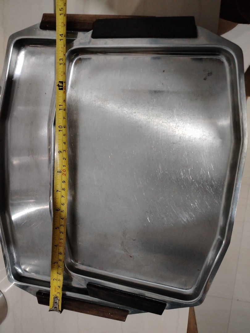 Vintage Serving Tray stainless with wooden handle (Bundle) (Category: Other Kitchenware & Tableware) located in Parang, Maguindanao. Submitted by lawon_koleksyon (Listing ID 1361937482, Image 2). Description: The image shows a mid-century modern serving tray, likely of Danish design. Key features include: Material: Stainless steel with teak handles. Style: Clean lines, typical of mid-century Danish design. Function: Used for serving food or drink