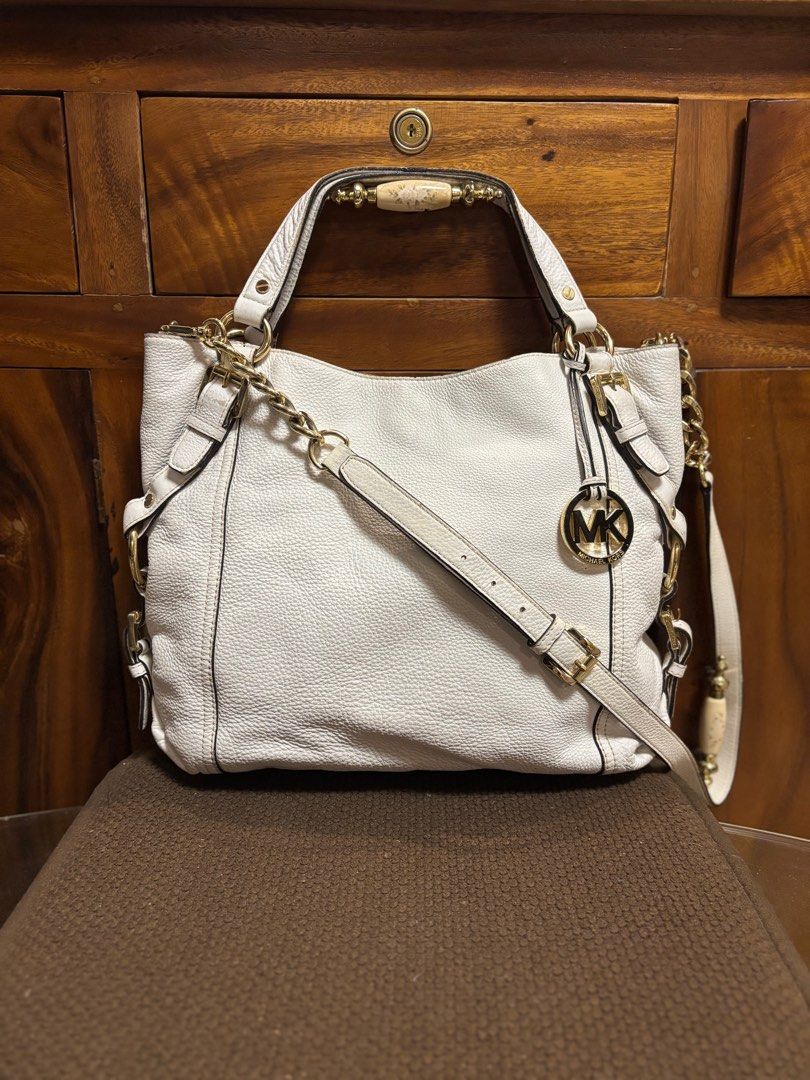 Preloved MK Two Way Leather Bag (Category: Luxury Bags & Wallets) located in Imus. Submitted by bagsofblessings24 (Listing ID 1362077795, Image 1). Description: Preloved Original Michael Kors With tag, code and hangtag Length 15in x Height 11in x Bottom 4in Very good condition except for the faded rubber lining, faded color in some parts and dirt on the bottom Gold hardwares Lightweight pebbled genuine leather Pm for any questions .