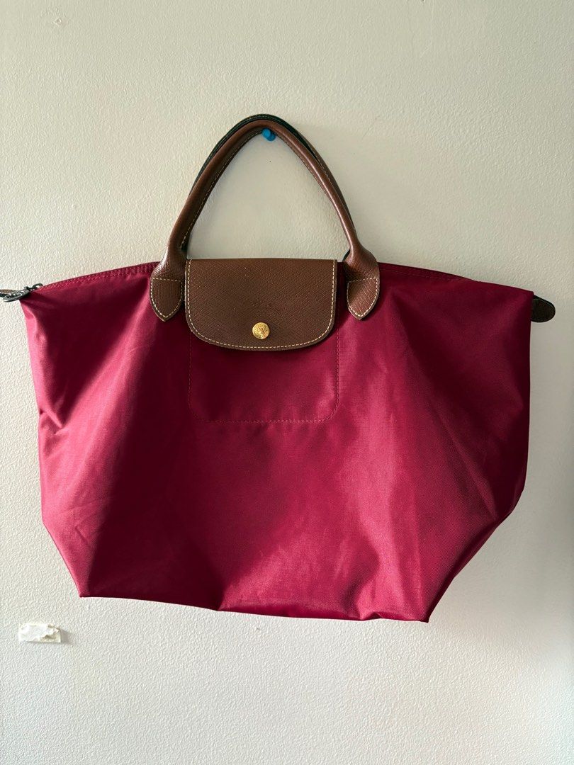Authentic Longchamp Le Pliage Bag Large Short Handle (Category: Luxury Bags & Wallets) located in Muntinlupa City. Submitted by take2mnl (Listing ID 1362133212, Image 1). Description: Authentic Longchamp Short Handle Bag In Excellent Used Condition Kindly self authenticate if in doubt. Color: Wine Red Super good deal. RFS: Bought a new one..