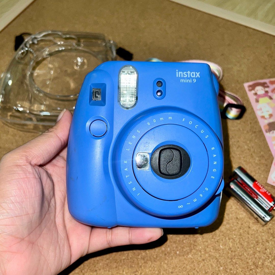 Instax Mini 9 (Category: Cameras) located in Makati City. Submitted by CameraHubPH (Listing ID 1362244314, Image 2). Description: Instax Mini 9 (Dark Blue) - In great condition - No issues and all working - 99% smooth 📸 INCLUSIONS: - Unit - Stickers for deco - Alkaline batts - Acrylic Case with rainbow strap 🤍NO return, exchange, and refund policy. 🤍Please note that these cameras are secondhand units. While they have been carefully tested, it 