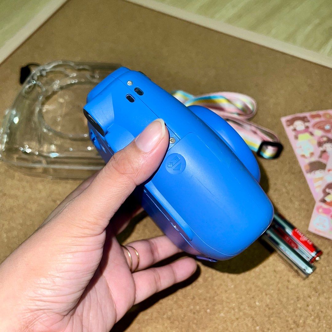 Instax Mini 9 (Category: Cameras) located in Makati City. Submitted by CameraHubPH (Listing ID 1362244314, Image 3). Description: Instax Mini 9 (Dark Blue) - In great condition - No issues and all working - 99% smooth 📸 INCLUSIONS: - Unit - Stickers for deco - Alkaline batts - Acrylic Case with rainbow strap 🤍NO return, exchange, and refund policy. 🤍Please note that these cameras are secondhand units. While they have been carefully tested, it 