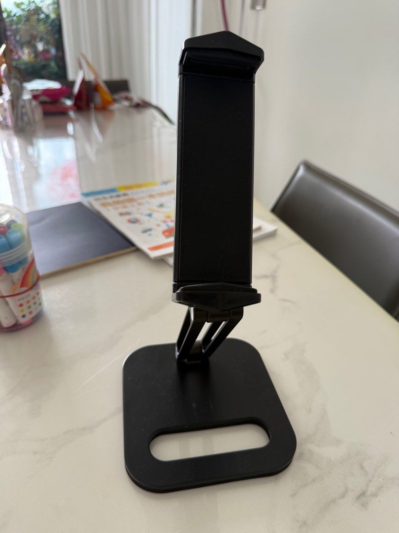 iPad stand (Category: Other Gadgets) located in Singapore. Submitted by cosmicdolphin_e430c0 (Listing ID 1362179799, Image 1). Description: Very stern Flexible to adjust height and orientation Quite heavy (so can hold weight) Black in color .