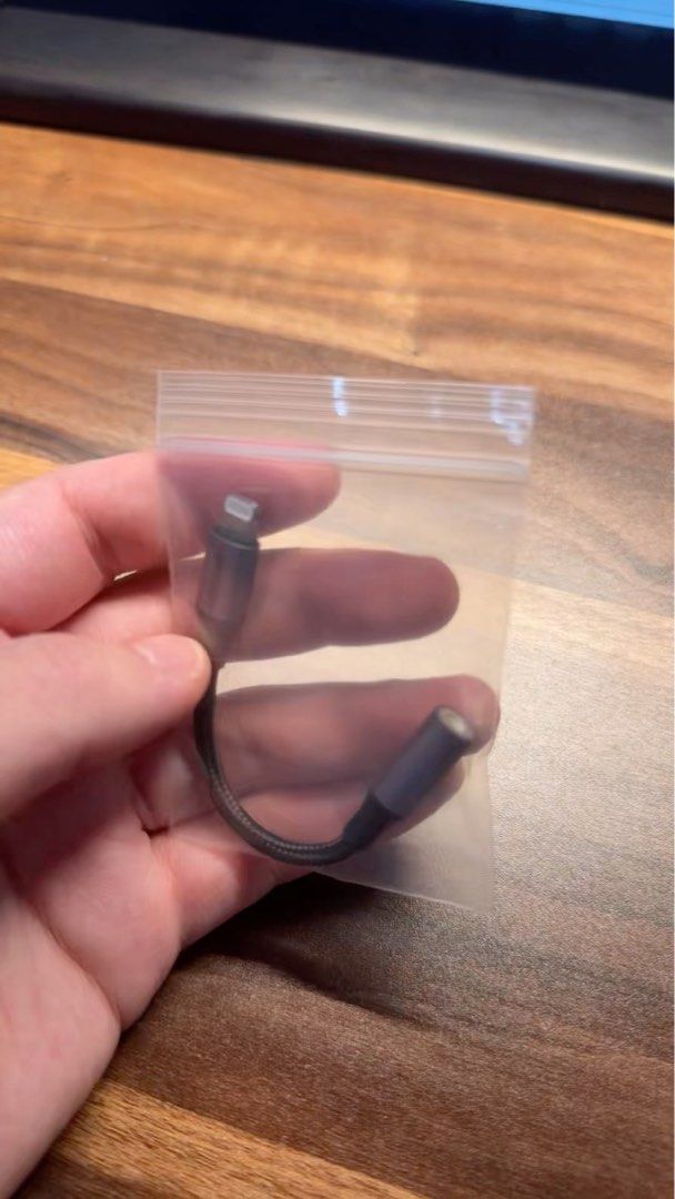 Lightning to Audio Jack Adapter (Category: Chargers & Cables) located in Singapore. Submitted by day_day_eat_rice (Listing ID 1362294339, Image 1). Description: This is a Lightning to Audio Jack adapter. It's in lightly used condition, and it's perfect for connecting your iPhone or iPad to headphones or speakers with a 3.5mm jack. It's a great way to enjoy your music on the go. .