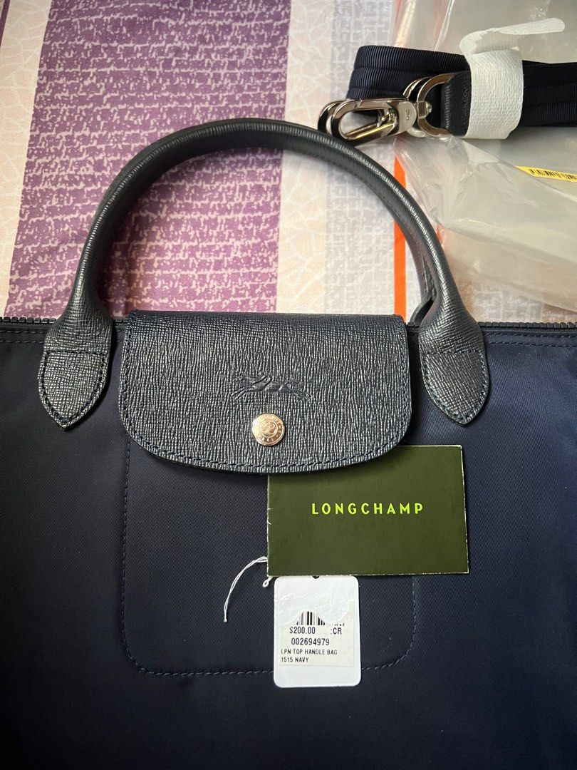 Longchamp Neo with crossbody strap (Category: Luxury Bags & Wallets) located in Mandaluyong City. Submitted by seafoamint (Listing ID 1362218469, Image 2). Description: Guaranteed Authentic Like new condition Navy color With non adjustable crossbody strap With care card Neo line has been discontinued. A great piece to add to your collection. Nylon is thicker than the le pliage line.
