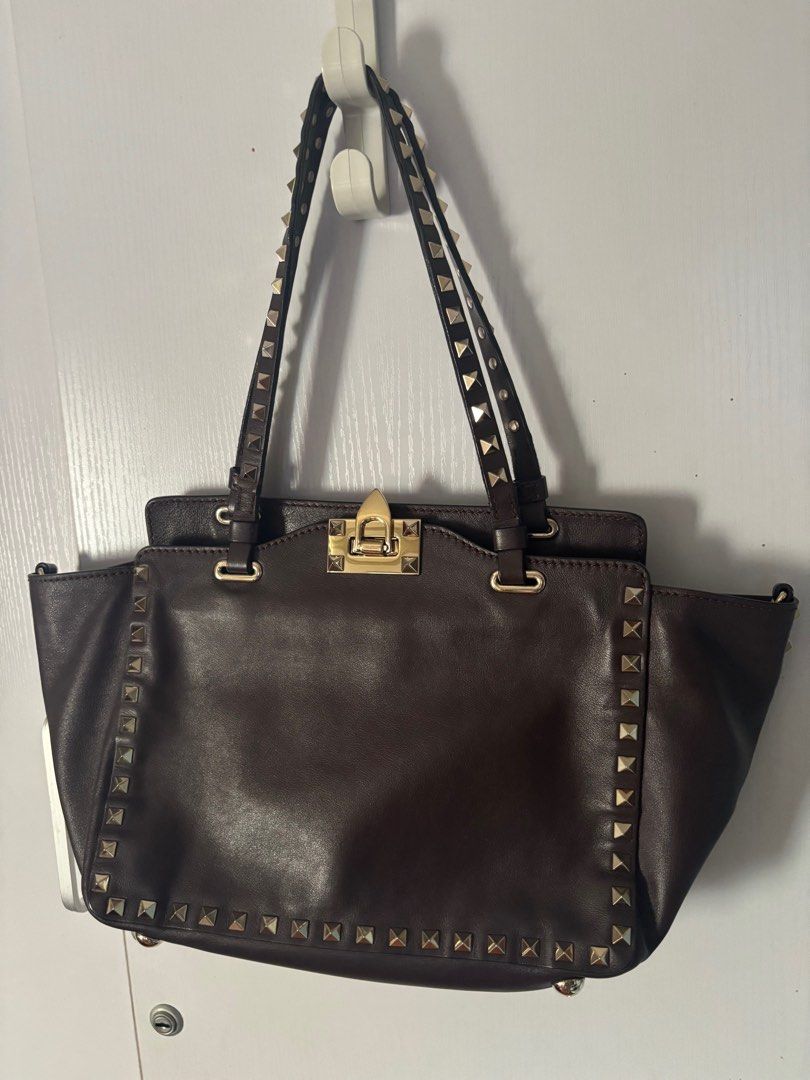 Valentino Rockstud Trapeze bag small (Category: Luxury Bags & Wallets) located in Makati City. Submitted by bravelion_cea1db (Listing ID 1362232715, Image 1). Description: Valentino Rockstud Trapeze bag small Color : dark eggplant 🍆 Gold hardware With dustbag and cards RFS: Decluttering .