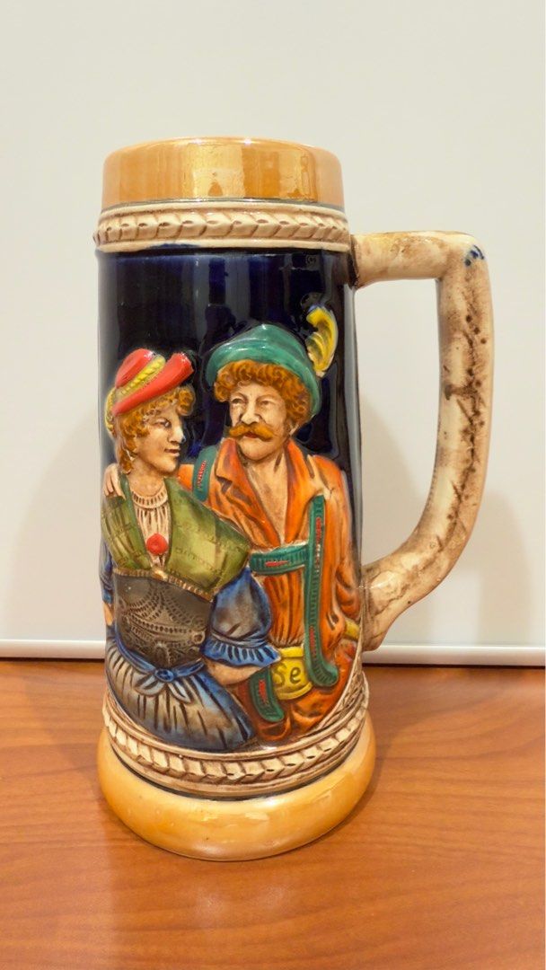 Vintage KW German Ceramic Stein Mug (Category: Other Kitchenware & Tableware) located in Binangonan. Submitted by c_r_i_s (Listing ID 1362160240, Image 1). Description: Vintage KW German Ceramic Stein Mug 8 1/4 inches tall. 5 inches wide with handle. Two and seven eights inch top diameter. Hand painted. Raised man, lady, and countryside on sides No chips and cracks. Very beautifully crafted! In excellent condition!.
