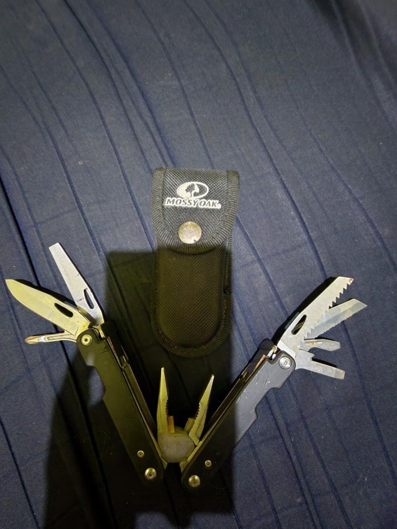 Mossy Oak Multi-tool (Category: Home Improvement Tools & Accessories) located in Manila. Submitted by savilaaa (Listing ID 1362440631, Image 2). Description: MOSSY OAK 21 in 1 Multi Function Pliers Stainless Steel Portable Pocket Knife with Sheath for Outdoors Survival Camping.