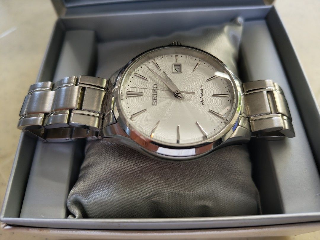 Seiko Neo Classic SRP701 Automatic men's watch (Category: Men's Watches) located in Quezon City. Submitted by racp2k8 (Listing ID 1362308442, Image 2). Description: Seiko Neo Classic SRP701 Automatic men's watch. May 2016 production date. 42mm case size, white sunburst wave dial. Known as "poor man's Grand Seiko". Resized, never worn. Like new/mint condition. 4R35 movement keeps good time. Comes with box, generic Seiko manual, tag, extra links, u