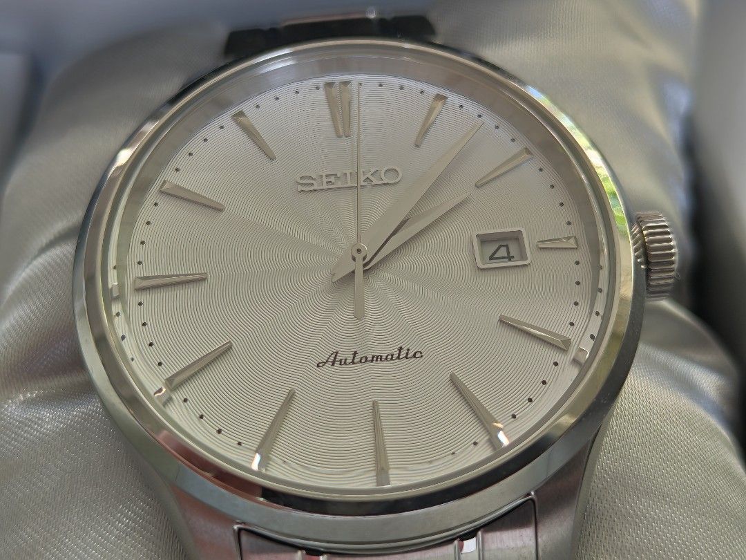Seiko Neo Classic SRP701 Automatic men's watch (Category: Men's Watches) located in Quezon City. Submitted by racp2k8 (Listing ID 1362308442, Image 1). Description: Seiko Neo Classic SRP701 Automatic men's watch. May 2016 production date. 42mm case size, white sunburst wave dial. Known as "poor man's Grand Seiko". Resized, never worn. Like new/mint condition. 4R35 movement keeps good time. Comes with box, generic Seiko manual, tag, extra links, u