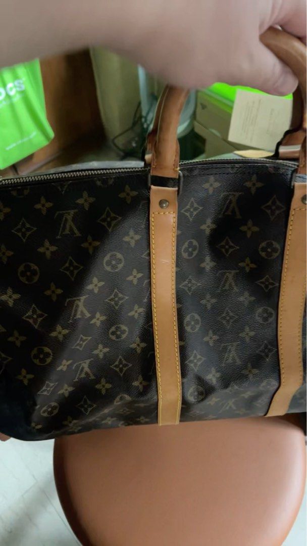Louis Vuitton Keepall 55 Travel Bag (Category: Bags & Wallets) located in Singapore. Submitted by dare2dr3am (Listing ID 1362492952, Image 3). Description: Authentic Louis Vuitton Keepall 55 travel bag for sale. This bag is in well-used condition, with some signs of wear and tear. The canvas is still in good condition, but there are some scratches on the leather trim. The zipper works smoothly and the bag is still very spacious. It's perfect for 