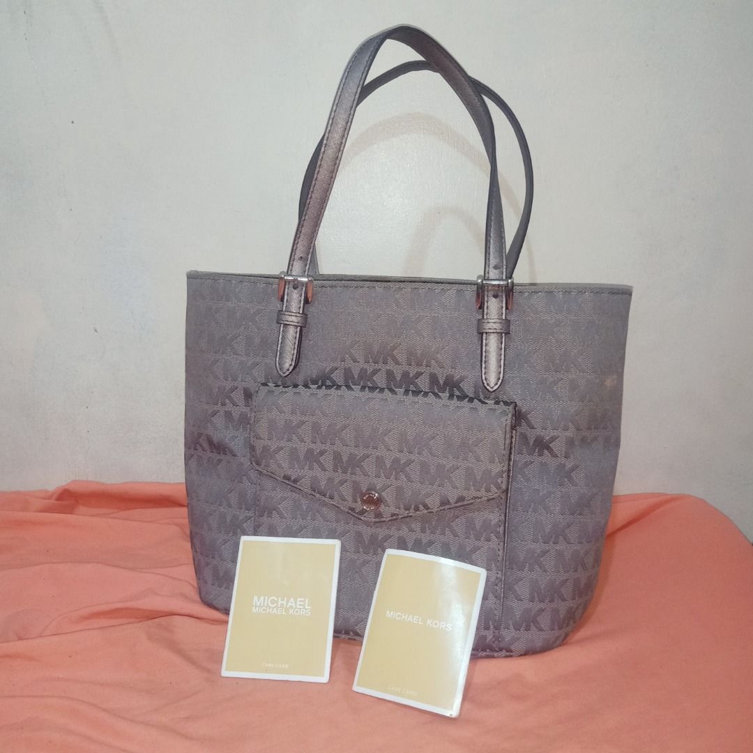 Authentic MK Gray Tote Bag (w/ care cards & QR code)) (Category: Luxury Bags & Wallets) located in Quezon City. Submitted by mari_x (Listing ID 1362753611, Image 1). Description: Legit MK Tote Bag with Care Cards & QR code From US Personal Bag Good as new Clean inside & out No flaws.