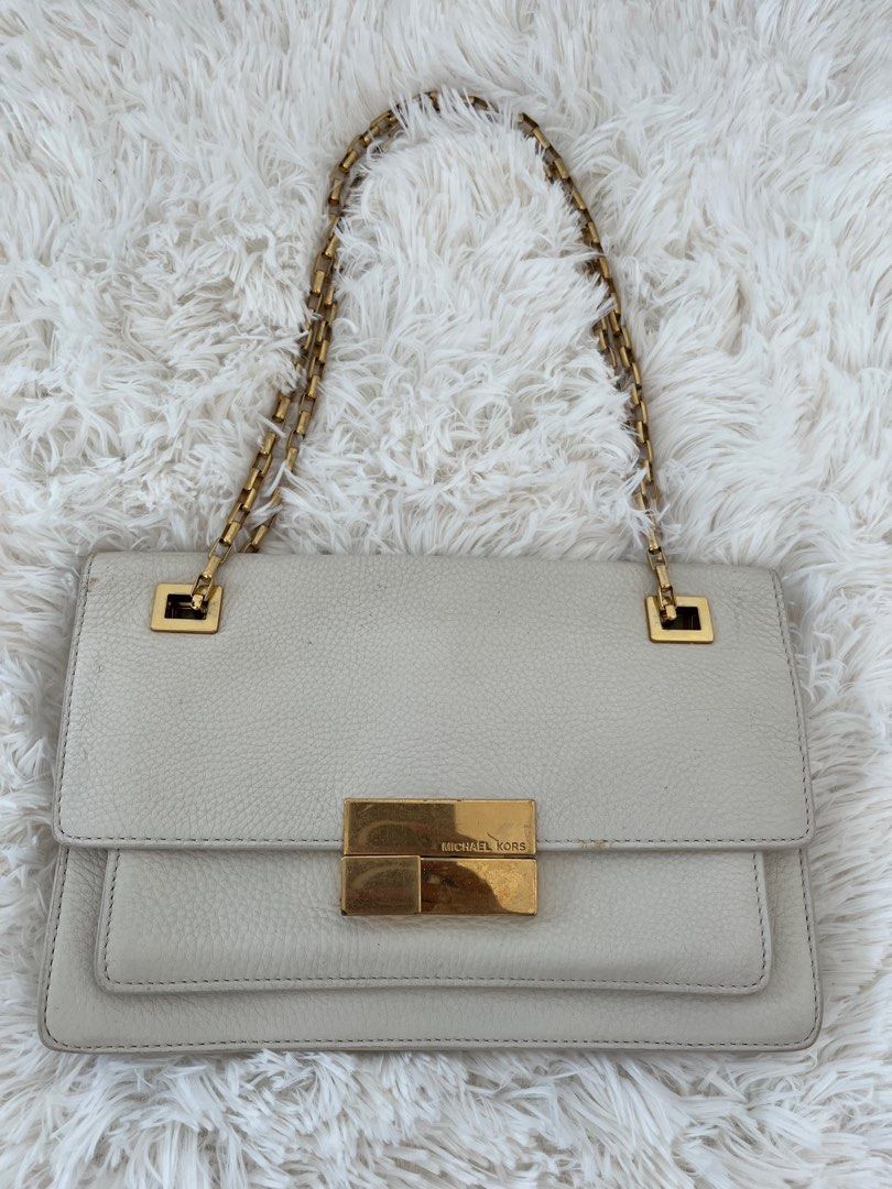 Michael Kors gold sling bag (Category: Luxury Bags & Wallets) located in San Jose. Submitted by mlvd31 (Listing ID 1362672614, Image 2). Description: Michael Kors gold sling bag Good condition but no damage Needs recoloring Negotiable .