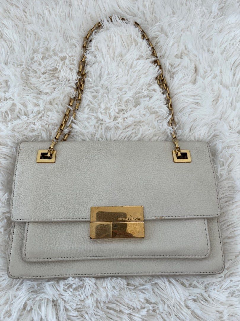 Michael Kors gold sling bag (Category: Luxury Bags & Wallets) located in San Jose. Submitted by mlvd31 (Listing ID 1362672614, Image 1). Description: Michael Kors gold sling bag Good condition but no damage Needs recoloring Negotiable .